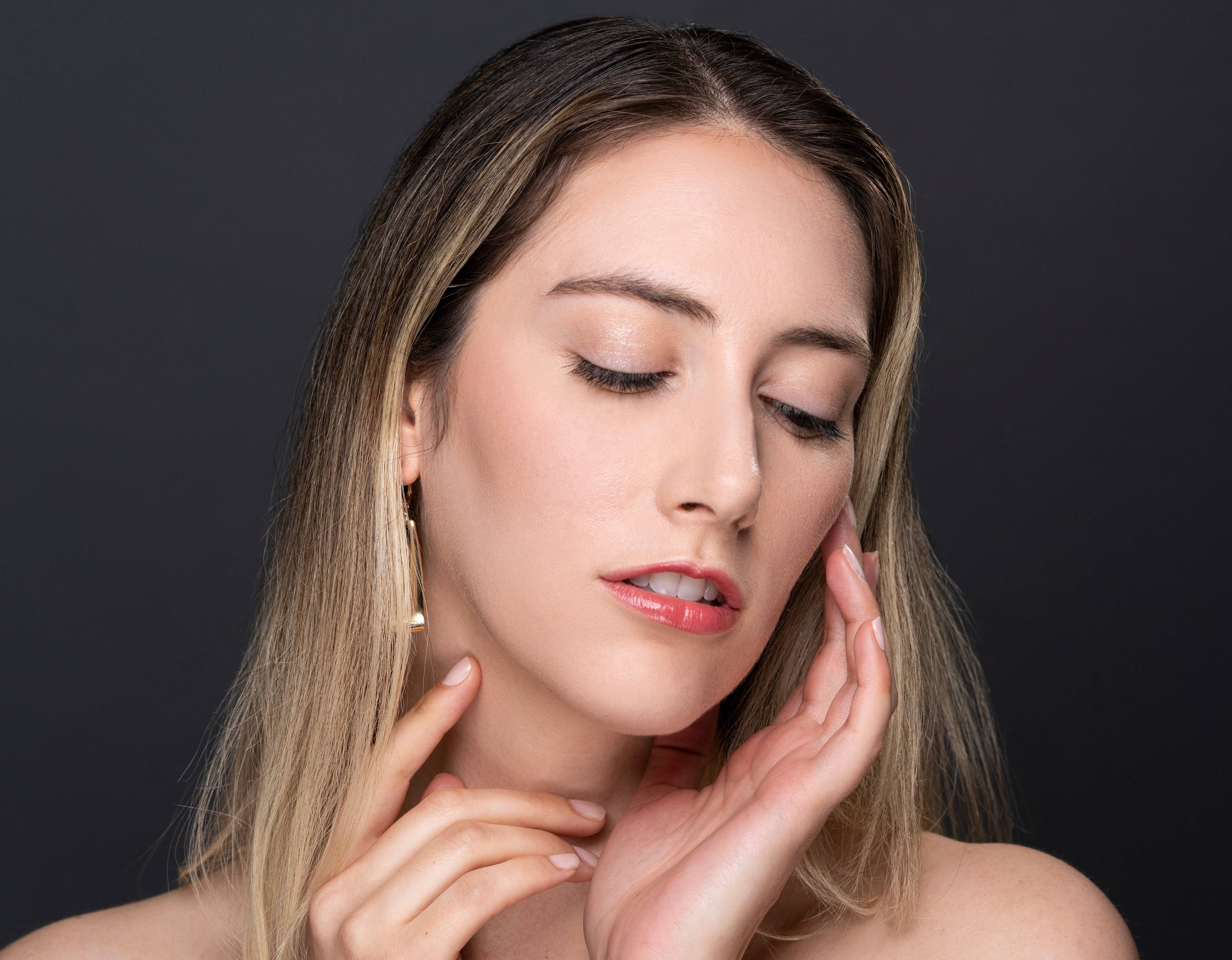 Woman touching face wearing Elegant Effect lashes