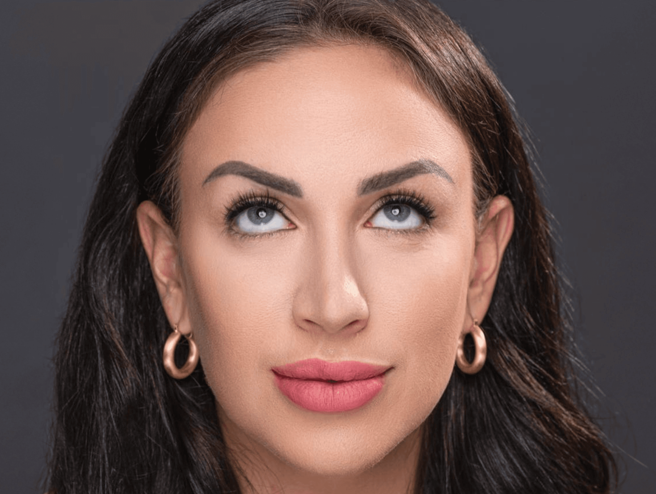 Woman looking up wearing Perfect Poise Lashes