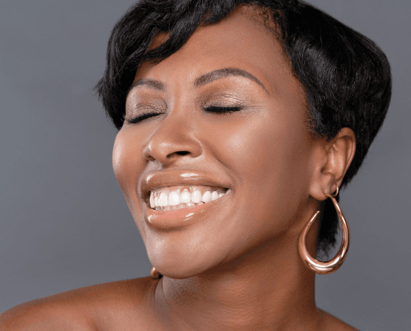Smiling woman with closed eyes wearing Ball Gown Lash Set