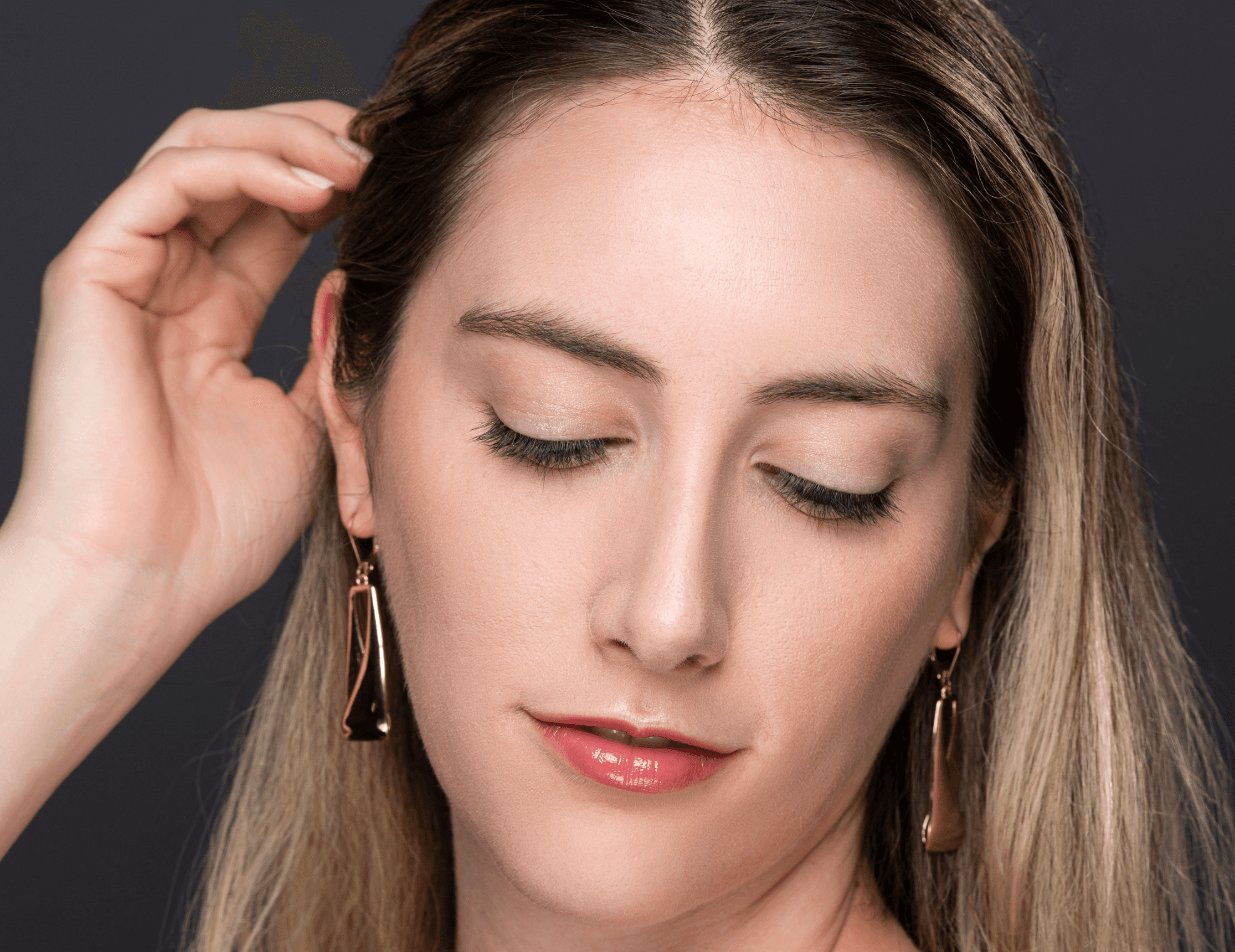 Woman with hand in hair wearing Elegant Effect lashes